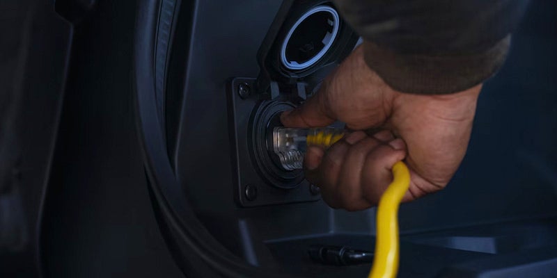 Image of a 2026 Chevrolet Silverado-EV parked in the garage and plugged-in to the wall, charging