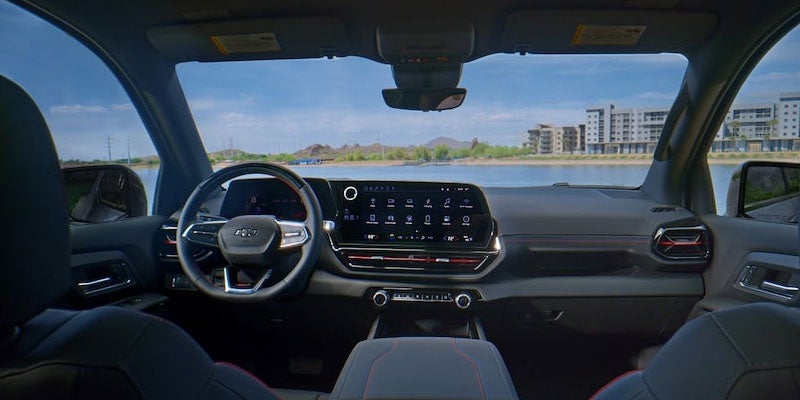 Image of a person connecting the charger to the 2025 Chevrolet Silverado-EV