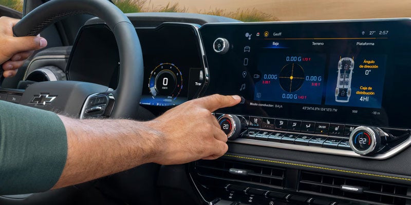Driver adjusting the 2026 Chevrolet Colorado's off-road drive mode display