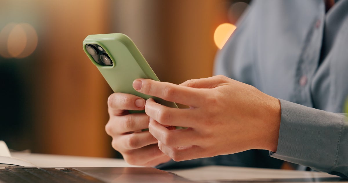 Image of a person-holding-phone to locate a charging station
